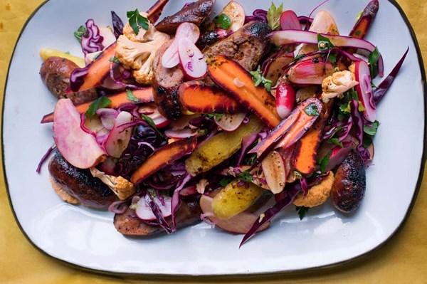 Chopped winter salad with slow-cooked sausages