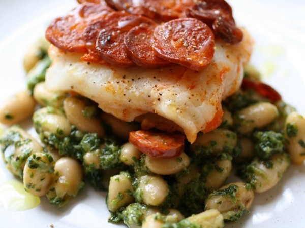 Chorizo crusted cod and beans with arugula pesto