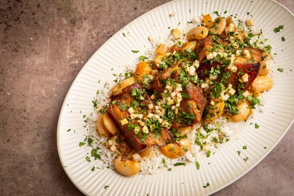 Cider-braised pork belly butter bean chilli with apple relish