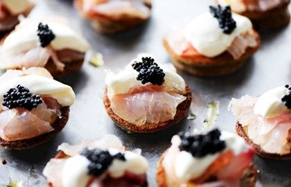 Citrus-cured sea bass on blinis with ossetra caviar and crème fraîche