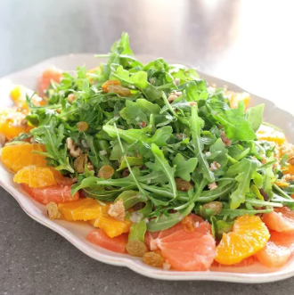 Citrus salad with arugula, golden raisins, and walnuts