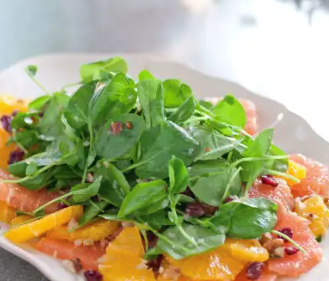 Citrus salad with arugula, golden raisins, and walnuts