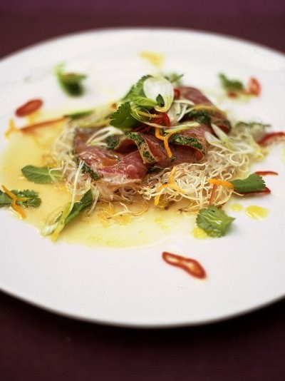 Citrus seared tuna with crispy noodles, herbs and chilli