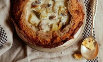 Clam chowder with Old Bay crackers in a sourdough bowl