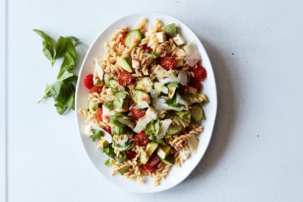Classic pasta salad with mozzarella, avocado and basil