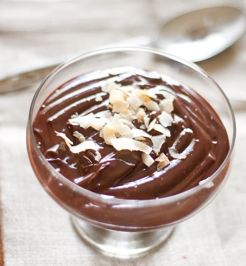 Coconut chocolate pudding with coconut flakes