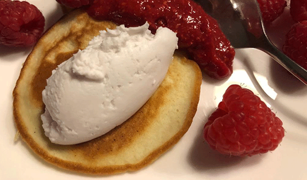Coconut pancakes, whipped coconut cream & raspberries