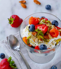 Coconut yogurt parfait with nuts, seeds, and fresh berries
