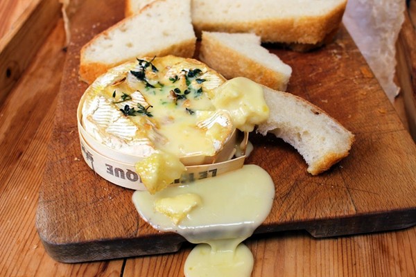 Cognac and garlic baked Camembert