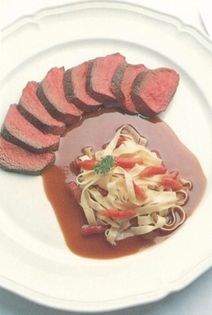Collops of venison with cranberry sauce, tagliatelle and bacon