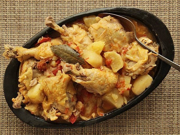 Colombian chicken stew with potatoes, tomato, and onion