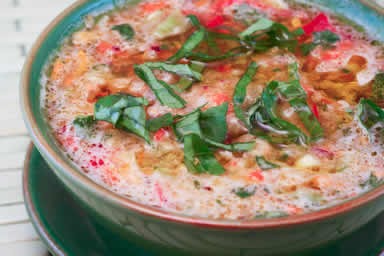 Confetti gazpacho with yellow tomatoes, red peppers, and basil