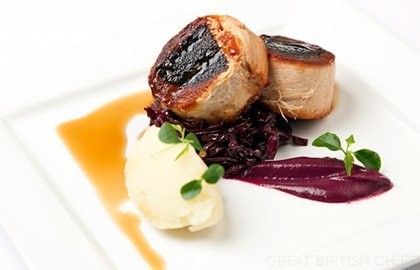 Confit belly of pork stuffed with black pudding with braised red cabbage, mash and cider jus