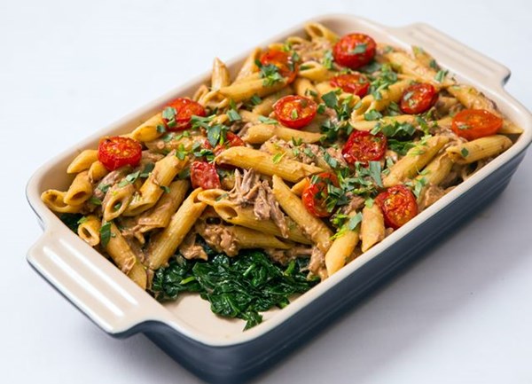 Confit duck leg with penne, spinach and tomato