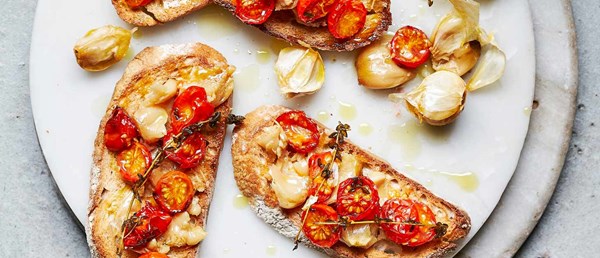 Confit garlic with roasted tomatoes on toast