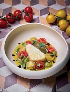 Confit salted cod with smoked aubergine purée and marinated cherry tomatoes (Baccalà in olio cottura con purea di melanzane affumicate e pomodorini marinati)