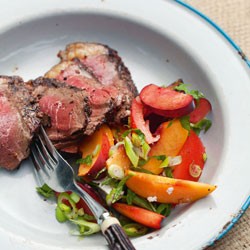 Coriander, thyme and orange beef with stone fruit, feta and tomato salad