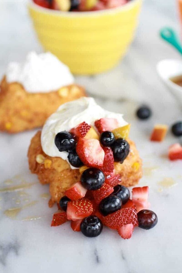 Corn fritters with coconut whipped cream and sweet honey bourbon syrup