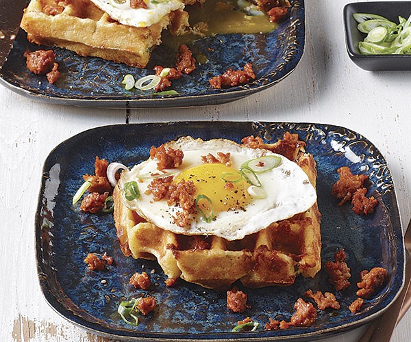 Cornmeal-cheddar-chipotle waffles with fried eggs and chorizo