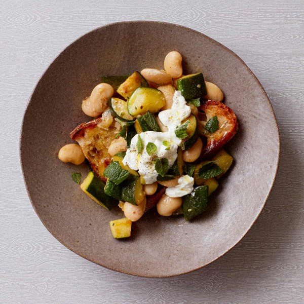 Courgette and butter bean stew with goat's curd