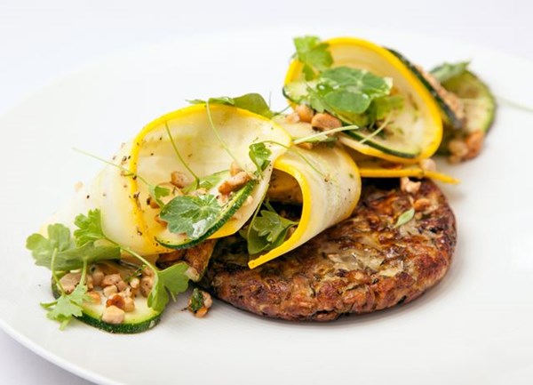 Courgette, spelt and cumin fritters, courgette, parsley and cashew salad