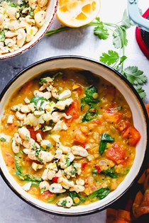 Cozy lemon, tomato, and cardamom dal with spicy cashew lemon salsa
