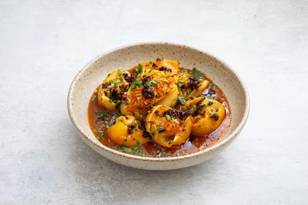 Crab-stuffed lumaconi with saffron bisque