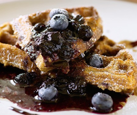 Cracked wheat waffles with cinnamon-allspice butter, blueberry syrup