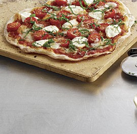 Cracker-thin pizza with cherry tomatoes, fresh mozzarella, ricotta and basil