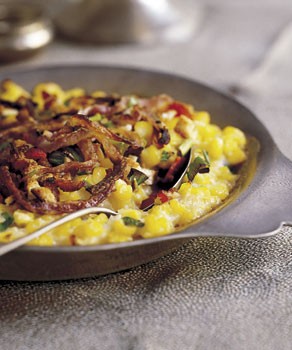 Creamed corn gratin with fried onion rings and bacon