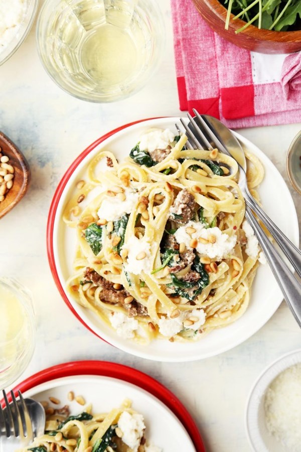 Creamed spinach pasta with sausage and pine nuts