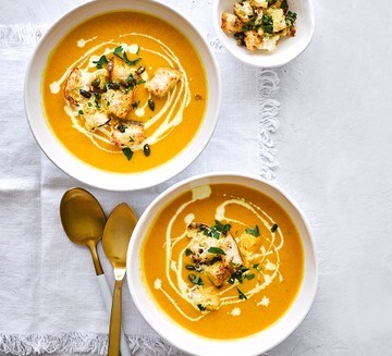 Creamy carrot soup with garlicky seeded croutons