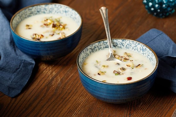 Creamy cauliflower soup with mushroom and hazelnut topping