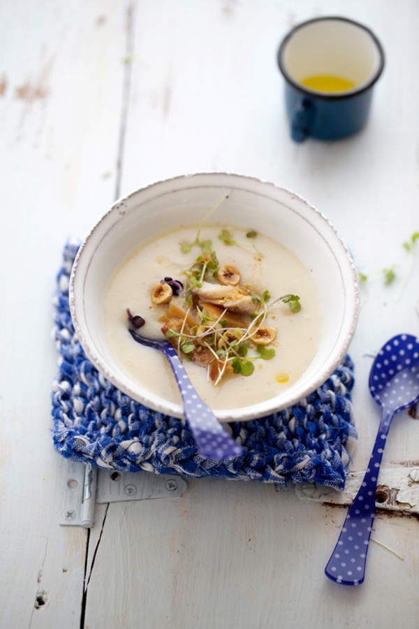 Creamy celery root and apple soup with smoked trout and hazelnuts
