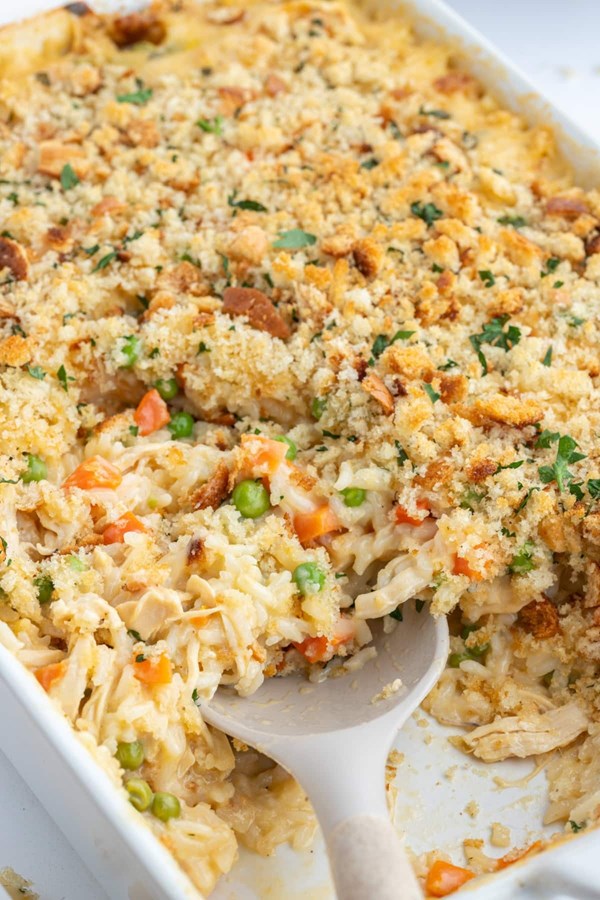 Creamy chicken and rice casserole with peas, carrots and cheddar