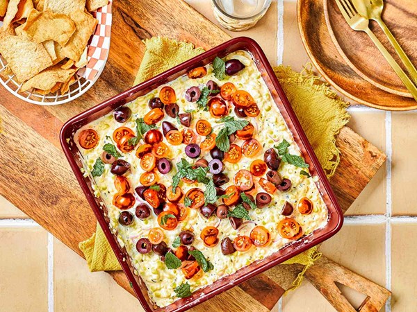 Creamy corn dip with feta, mint, and tomatoes