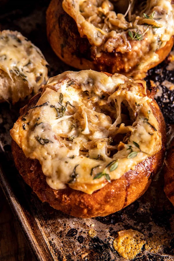 Creamy French onion soup in bread bowls