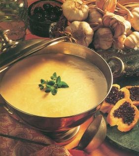 Creamy garlic soup with black olive crostini