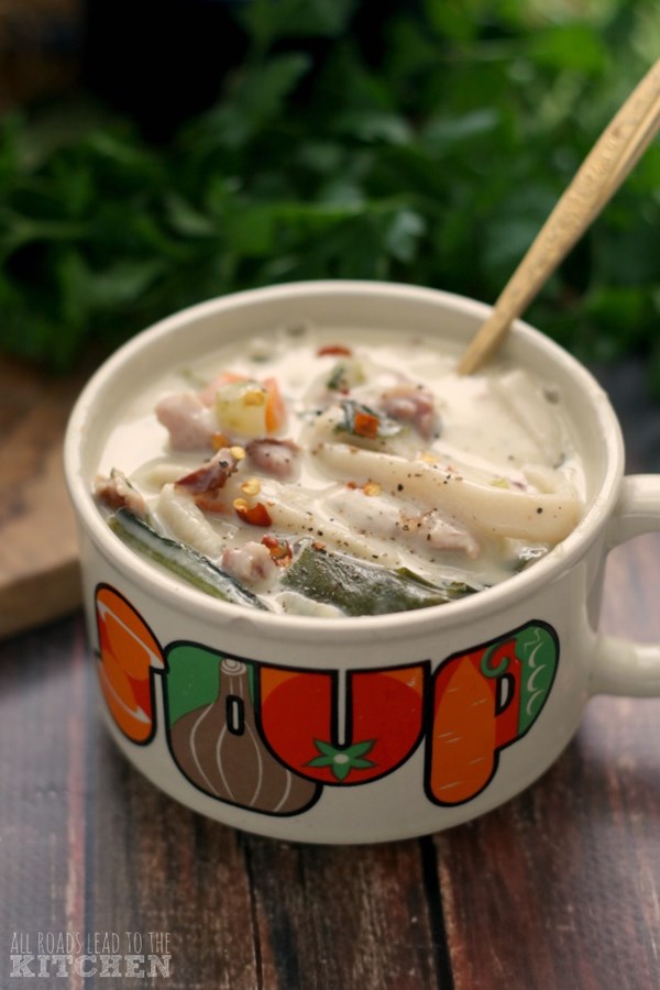 Creamy ham and greens noodle soup