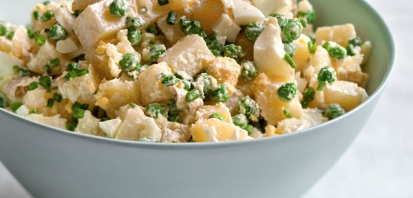 Creamy potato salad with eggs, peas, and chives