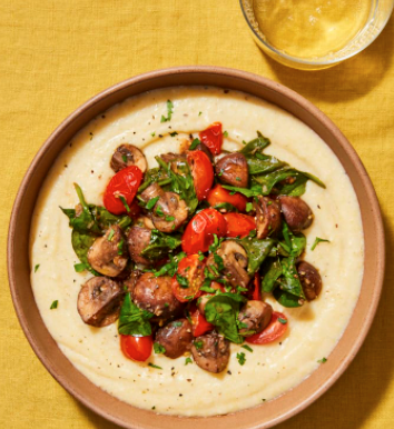 Creamy vegan polenta with mushrooms, tomatoes and spinach