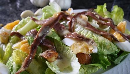 Crisp lettuce, anchovy, egg and crouton salad with a creamy vinaigrette