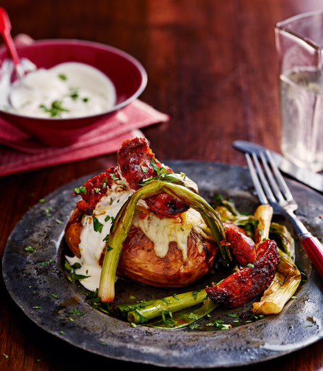 Crisp-skinned jackets with cheese, chorizo and spring onions