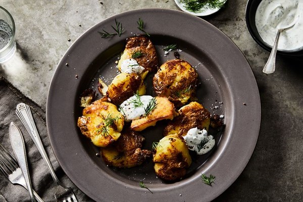 Crisp-smashed yellow potatoes with sour cream and vinegar dill sauce