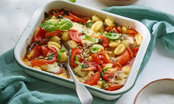 Crispy baked gnocchi with tomatoes, basil, mozzarella and pine nuts
