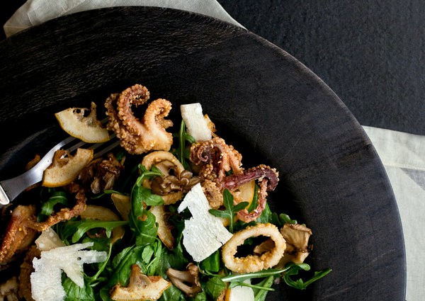 Crispy calamari, lemon and maitake salad over arugula