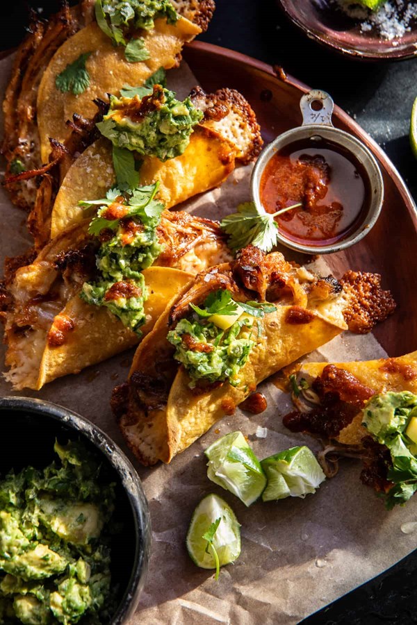 Crispy carnitas tacos with roasted jalapeño lime avocado