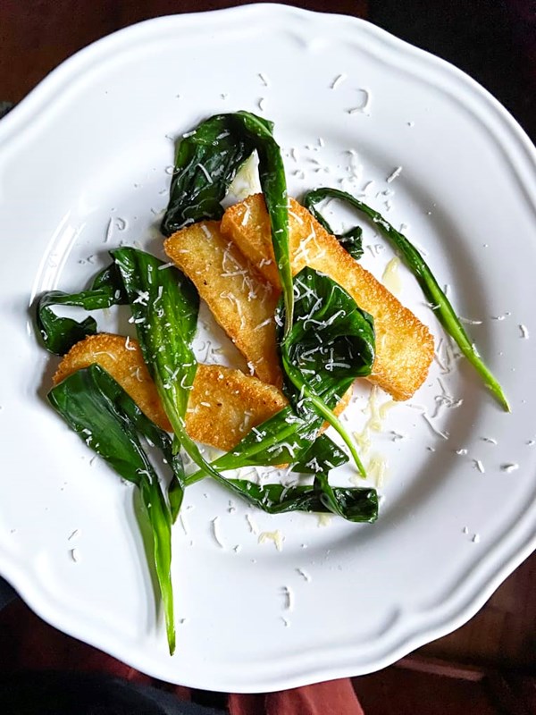 Crispy, cheesy polenta cakes with wilted ramps