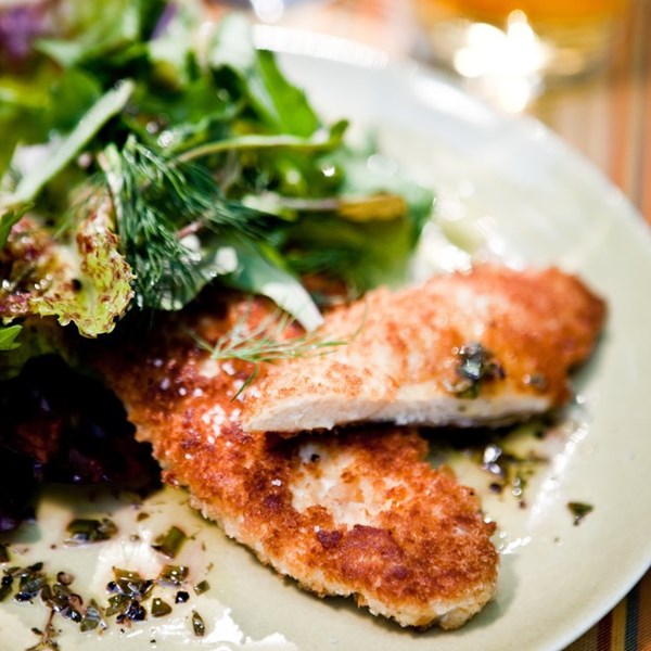 Crispy chicken cutlets with a heap of spring salad