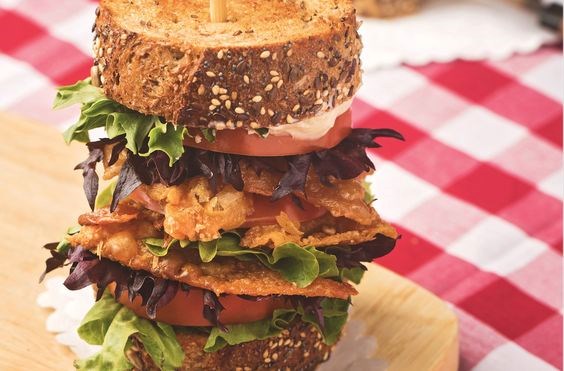 Crispy chicken skin, lettuce, and tomato sandwich with tarragon mayo